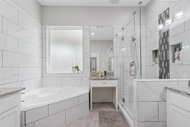 4511 Palo Pinto Dr, Houston, TX 77041 - full bathroom with vanity, a garden tub, a stall shower, and wood finished floors
