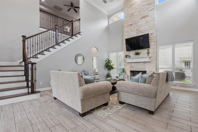 4511 Palo Pinto Dr, Houston, TX 77041 - living area featuring a fireplace, a high ceiling, stairs, ceiling fan, and wood finish floors