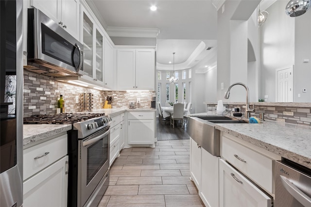 4511 Palo Pinto Dr, Houston, TX 77041 - kitchen with stainless steel appliances, backsplash, white cabinets, light stone counters, and recessed lighting