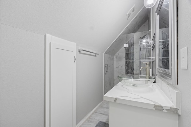 4511 Palo Pinto Dr, Houston, TX 77041 - full bath with marble look tiles, vanity, a marble finish shower, and lofted ceiling