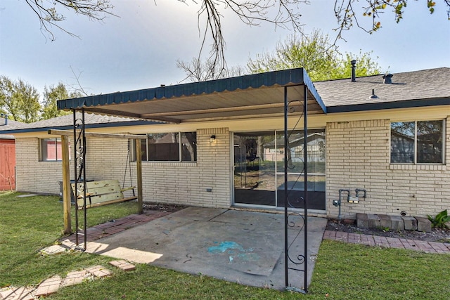 1310 Beaver Bend Rd, Houston, TX 77088 - back of house featuring brick siding, a lawn, a patio area, and a shingled roof