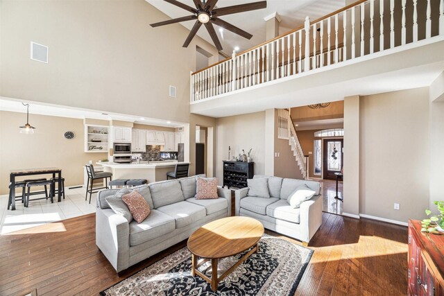3919 Park Circle Way, Houston, TX 77059 - living area featuring a high ceiling, ceiling fan, stairway, and wood-type flooring