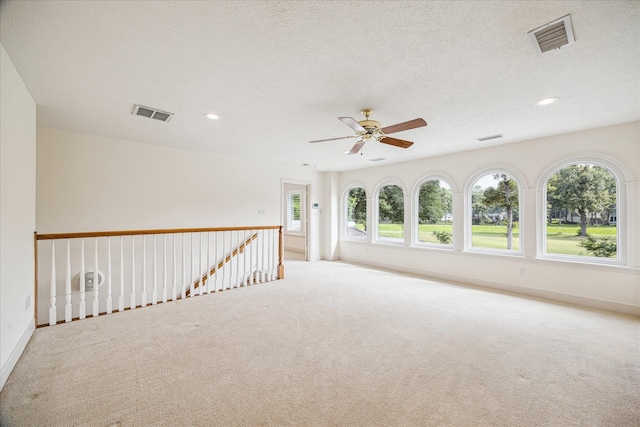 30 Halfmoon Ct, The Woodlands, TX 77380 - carpeted empty room with plenty of natural light, ceiling fan, recessed lighting, and a textured ceiling