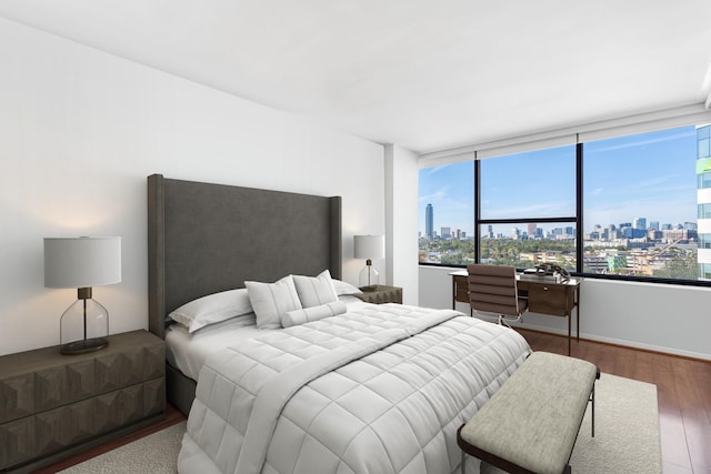 14 Greenway Plz Unit 12L, Houston, TX 77046 - bedroom featuring a skyline view, wood finished floors, and a desk