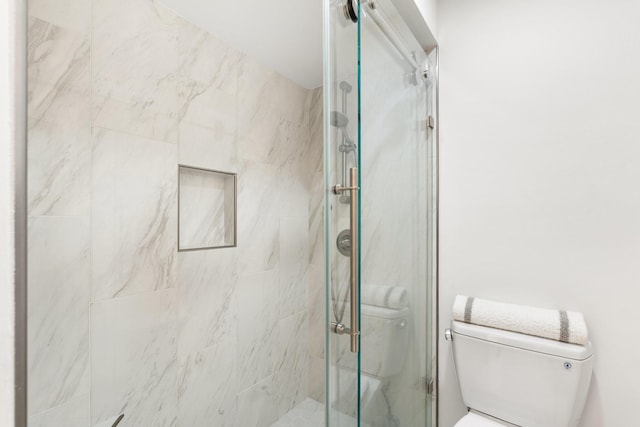 14 Greenway Plz Unit 12L, Houston, TX 77046 - full bathroom with a stall shower and toilet