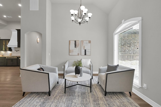 2172 Greentree Dr, Huntsville, TX 77340 - sitting room featuring wood finished floors, a chandelier, arched walkways, high vaulted ceiling, and recessed lighting