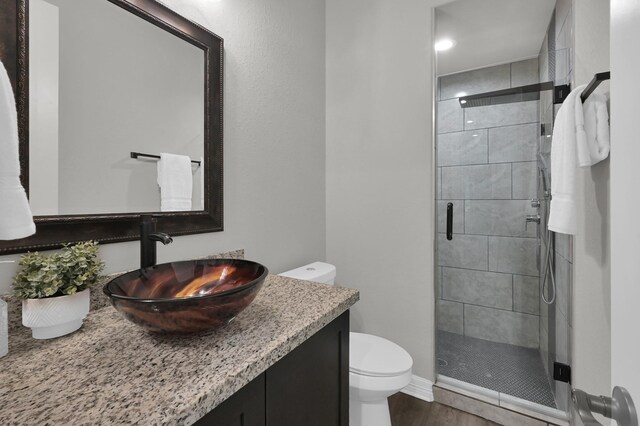 2172 Greentree Dr, Huntsville, TX 77340 - bathroom featuring a stall shower, vanity, and wood finished floors