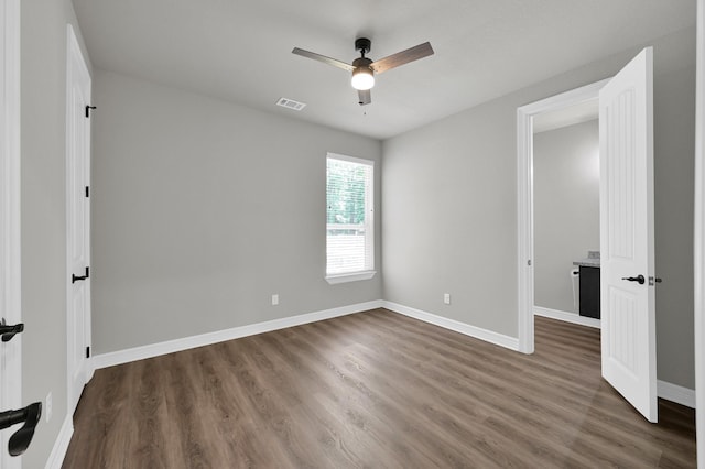 2172 Greentree Dr, Huntsville, TX 77340 - unfurnished bedroom with dark wood-style flooring and a ceiling fan