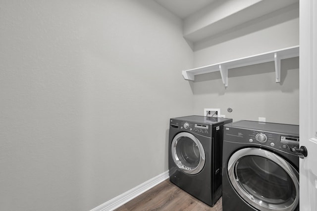 2172 Greentree Dr, Huntsville, TX 77340 - washroom with washer and dryer and wood finished floors