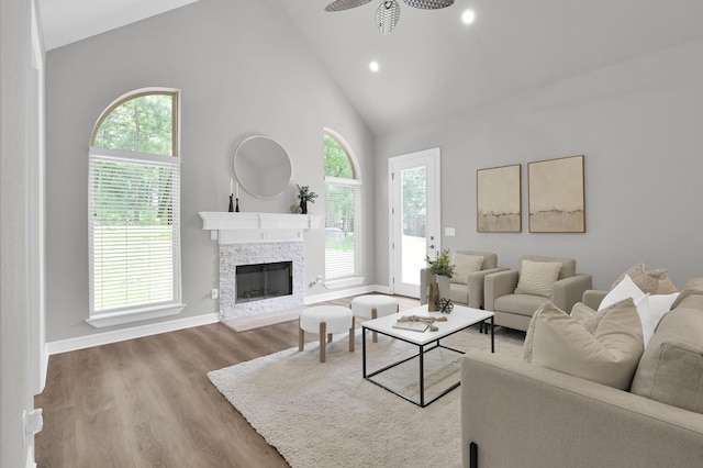 2172 Greentree Dr, Huntsville, TX 77340 - living area featuring a ceiling fan, high vaulted ceiling, plenty of natural light, a fireplace, and wood finished floors