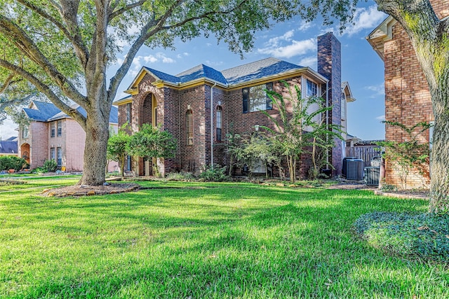 1526 Pecan Crossing Dr, Richmond, TX 77406 - view of front facade featuring brick siding, a front yard, and a chimney