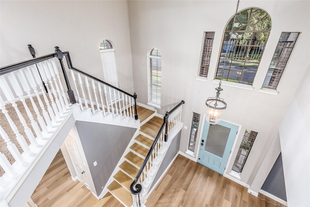 1526 Pecan Crossing Dr, Richmond, TX 77406 - stairs with a high ceiling, wood finished floors, and plenty of natural light