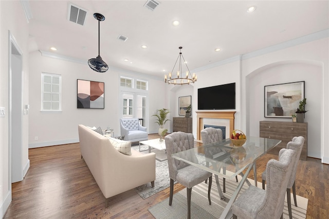 1048 W 21st St, Houston, TX 77008 - living room featuring a chandelier, wood finished floors, ornamental molding, and recessed lighting