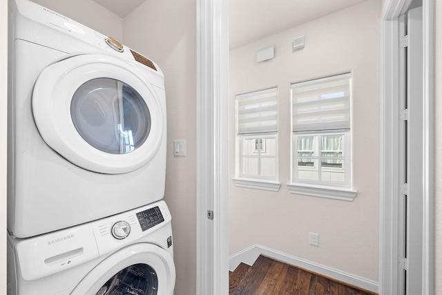 1048 W 21st St, Houston, TX 77008 - washroom featuring stacked washer / dryer and dark wood-style flooring