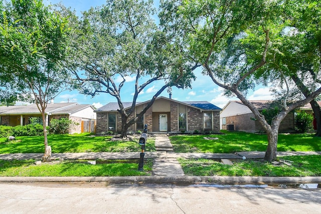 14511 Lourdes Dr, Houston, TX 77049 - mid-century modern home with a front yard and brick siding
