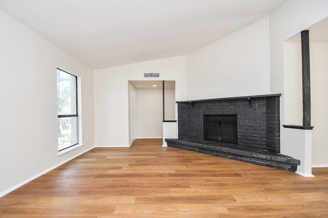 14511 Lourdes Dr, Houston, TX 77049 - unfurnished living room featuring vaulted ceiling, wood finished floors, and a fireplace