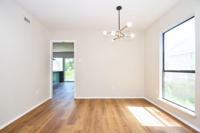 14511 Lourdes Dr, Houston, TX 77049 - spare room featuring a chandelier and light wood-type flooring