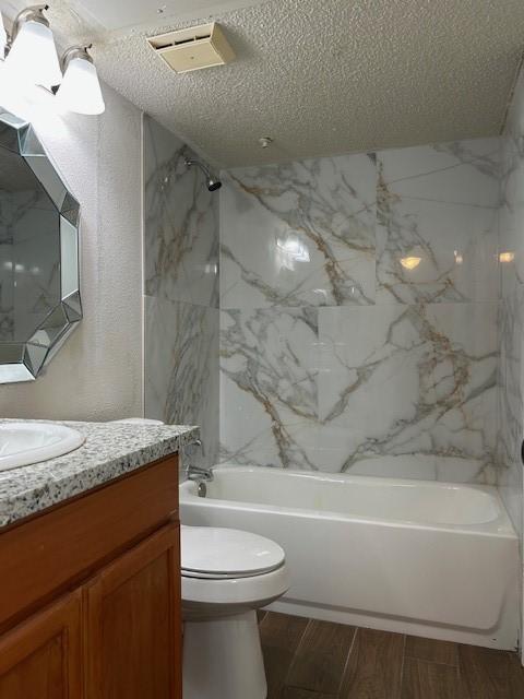 10555 Turtlewood Ct Unit 2111, Houston, TX 77072 - full bathroom featuring vanity, a textured ceiling, shower / bathtub combination, and wood tiled floors