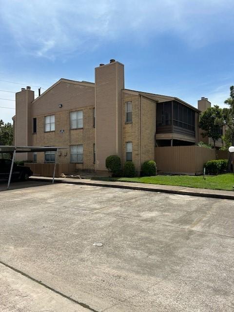 10555 Turtlewood Ct Unit 2111, Houston, TX 77072 - view of property featuring covered parking