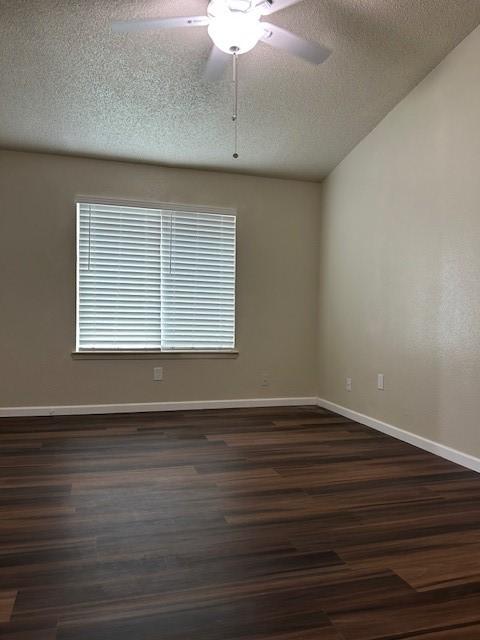 10555 Turtlewood Ct Unit 2111, Houston, TX 77072 - empty room with ceiling fan, dark wood-style floors, and a textured ceiling