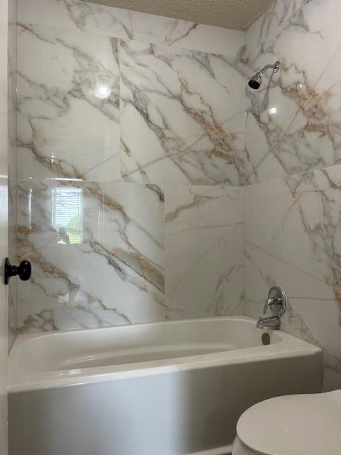 10555 Turtlewood Ct Unit 2111, Houston, TX 77072 - bathroom with shower / washtub combination and a textured ceiling