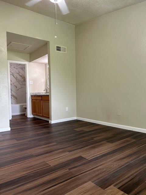 10555 Turtlewood Ct Unit 2111, Houston, TX 77072 - unfurnished room featuring ceiling fan, dark wood-type flooring, and attic access