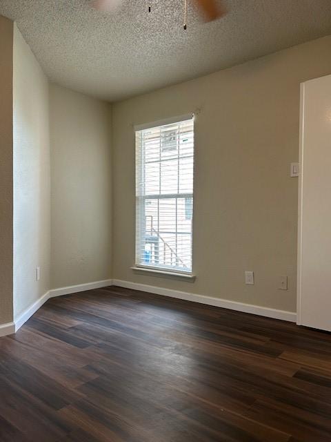 10555 Turtlewood Ct Unit 2111, Houston, TX 77072 - unfurnished room with a ceiling fan, dark wood-type flooring, and a textured ceiling