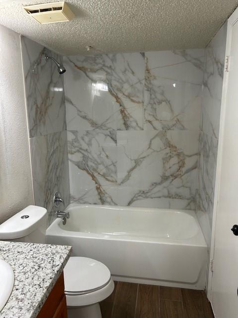 10555 Turtlewood Ct Unit 2111, Houston, TX 77072 - full bathroom featuring vanity, a textured ceiling, shower / bath combination, and wood finished floors