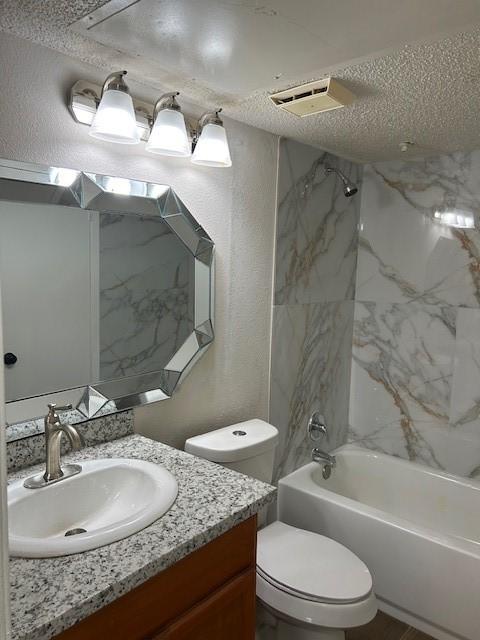 10555 Turtlewood Ct Unit 2111, Houston, TX 77072 - full bathroom with vanity, washtub / shower combination, a textured wall, and a textured ceiling