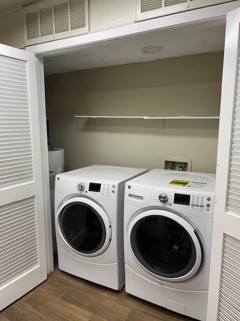 10555 Turtlewood Ct Unit 2111, Houston, TX 77072 - laundry area featuring independent washer and dryer and wood finished floors