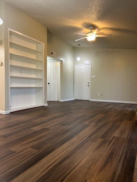10555 Turtlewood Ct Unit 2111, Houston, TX 77072 - empty room with a ceiling fan, a textured ceiling, and dark wood finished floors