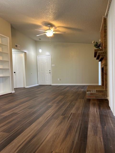 10555 Turtlewood Ct Unit 2111, Houston, TX 77072 - unfurnished living room featuring a textured ceiling, dark wood-style flooring, and ceiling fan