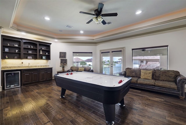 7507 Emerald Meadow Ct, Katy, TX 77494 - playroom featuring a raised ceiling, wine cooler, bar, ornamental molding, and dark wood-style floors