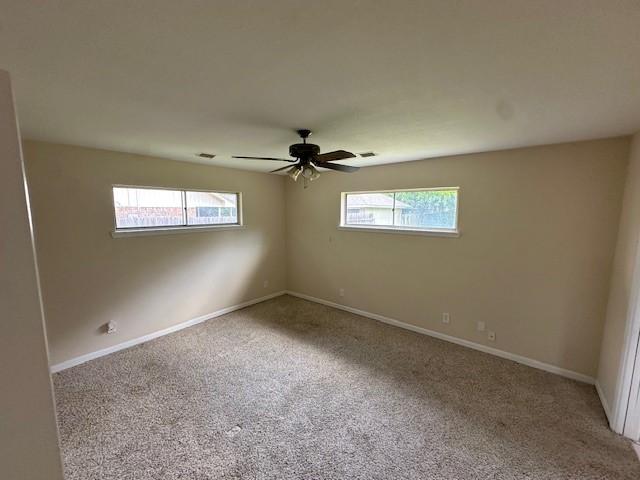 3900 Aggie Dr, Bay City, TX 77414 - spare room featuring carpet and a ceiling fan