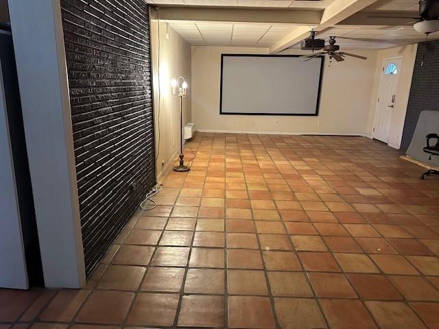 3900 Aggie Dr, Bay City, TX 77414 - cinema room with a ceiling fan, brick wall, tile patterned floors, and beamed ceiling