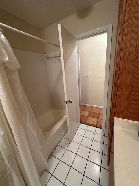 3900 Aggie Dr, Bay City, TX 77414 - bathroom featuring tile patterned floors, shower / bathtub combination with curtain, and vanity