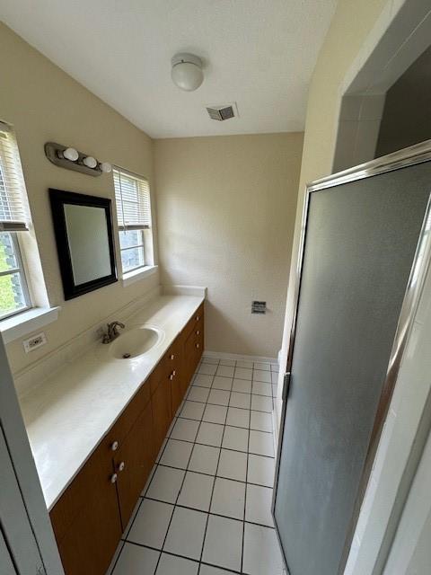 3900 Aggie Dr, Bay City, TX 77414 - bathroom with vanity, healthy amount of natural light, tile patterned floors, and a shower stall