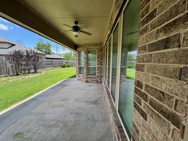 12911 Long Hunter Ct, Humble, TX 77346 - fenced backyard with ceiling fan and a patio area