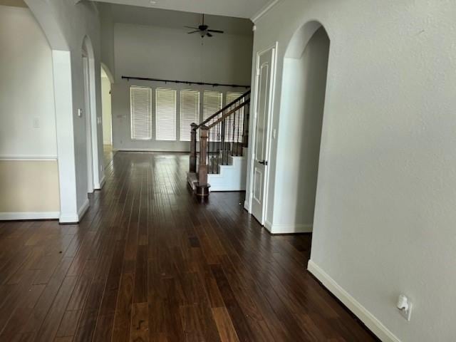 12911 Long Hunter Ct, Humble, TX 77346 - hallway featuring arched walkways, dark wood-type flooring, and stairs