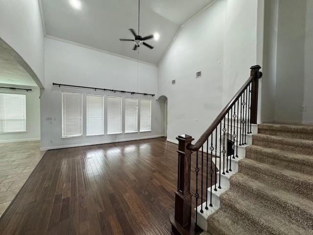 12911 Long Hunter Ct, Humble, TX 77346 - unfurnished living room featuring high vaulted ceiling, arched walkways, a ceiling fan, plenty of natural light, and ornamental molding