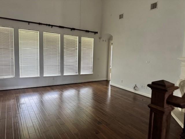 12911 Long Hunter Ct, Humble, TX 77346 - spare room with hardwood / wood-style floors, arched walkways, and a towering ceiling