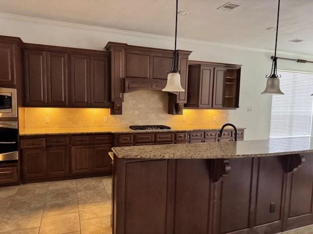 12911 Long Hunter Ct, Humble, TX 77346 - kitchen featuring stainless steel microwave, gas cooktop, decorative backsplash, crown molding, and light stone counters