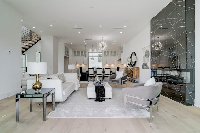 1022 Allston St, Houston, TX 77008 - living area featuring stairway, a chandelier, light wood finished floors, and recessed lighting