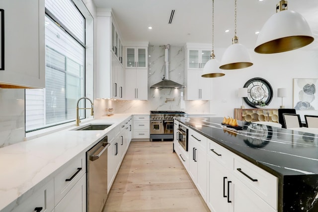 1022 Allston St, Houston, TX 77008 - kitchen featuring appliances with stainless steel finishes, decorative backsplash, light wood finished floors, white cabinets, and glass insert cabinets