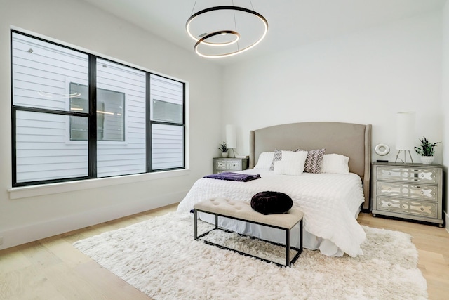 1022 Allston St, Houston, TX 77008 - bedroom with a chandelier and wood finished floors