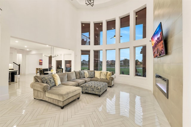 19303 Tree Canopy Ct, Cypress, TX 77433 - living area with a chandelier, a towering ceiling, ceiling fan, a fireplace, and recessed lighting