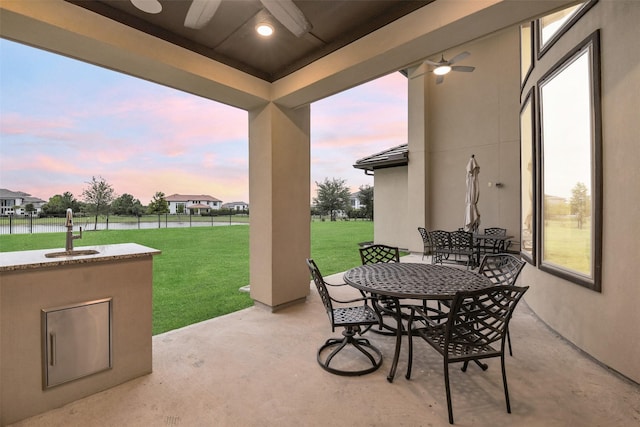 19303 Tree Canopy Ct, Cypress, TX 77433 - view of patio with a ceiling fan, outdoor dining area, and a water view