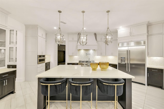 19303 Tree Canopy Ct, Cypress, TX 77433 - kitchen featuring stainless steel appliances, custom exhaust hood, backsplash, and white cabinetry