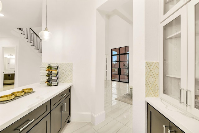 19303 Tree Canopy Ct, Cypress, TX 77433 - bar with decorative light fixtures, decorative backsplash, and light tile patterned flooring