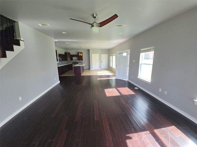 146 Disney St, Arcola, TX 77583 - unfurnished living room with wood finished floors, a ceiling fan, and stairs